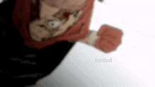 a blurry picture of a person 's face with a red scarf around their neck .