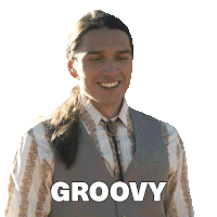 a man with long hair is smiling with the word groovy above him