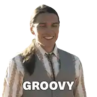 a man with long hair is smiling with the word groovy above him