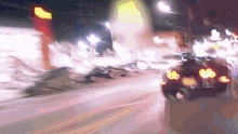 a blurry image of a car driving down a street at night