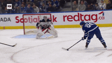 a hockey game is being played in front of an ad for redtag