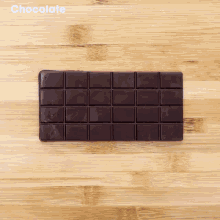 a bar of chocolate is on a wooden table