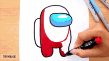 someone is drawing an among us character with a marker