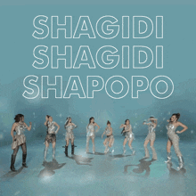 a group of women dancing in front of a sign that says shagido shagido shapopo