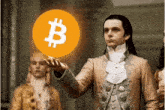 a man in a suit holds up a coin with a b on it