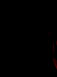 a close up of a person 's face with a red light behind them