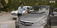 wiping balram the white tiger cleaning car