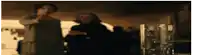 a blurry picture of a man pointing a gun at another man