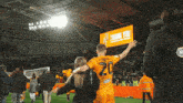 a soccer player with the number 20 on his jersey stands in front of a sign that says thank you