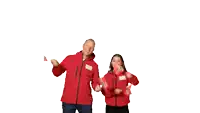 a man and a woman in red jackets are holding flags in front of their faces