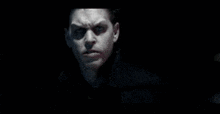 a man is sitting at a picnic table in the dark