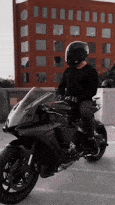 a man wearing a helmet is riding a motorcycle