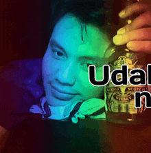 a man is holding a bottle of chivas whisky