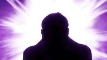 a silhouette of a man 's head is against a purple background