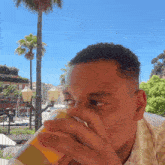 a man drinking from a bottle that says coca cola