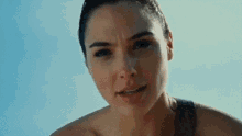 a close up of a woman 's face with a blue background .