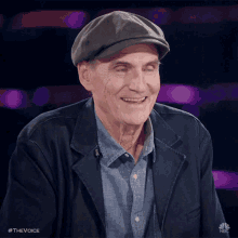a man wearing a hat and a jacket is smiling for the camera with the hashtag #thevoice