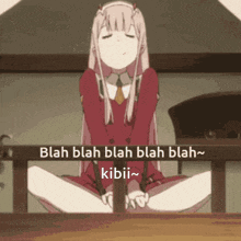 a girl in a red dress is sitting on the floor with her legs crossed