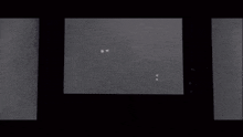a black and white photo of sparks coming out of a building