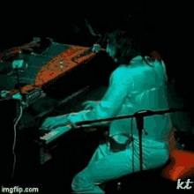 a person is playing a piano in a dark room with imgflip.com written on the bottom