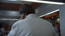 a man is talking on a cell phone in a room