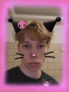 a young man with a cat face and a skull on his ears