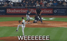 a baseball game is being played with a budweiser ad in the outfield