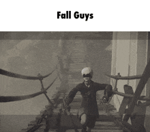 a black and white photo of a man on a bridge with the words fall guys above him