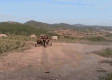 a person is driving a atv on a dirt road .
