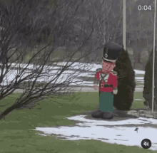 an inflatable nutcracker is standing in a snowy yard