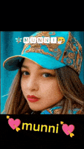 a picture of a woman wearing a blue baseball cap with the name munni on it