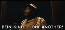 a man with his arms outstretched says bein ' kind to one another .