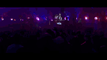 a blurry picture of a man playing a guitar on stage