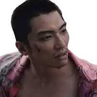 a man with a bandage on his face is wearing a pink shirt with a paisley pattern