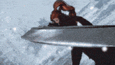 a woman with red hair holds a large sword