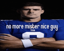 a man in a new york giants jersey has his arms crossed and says no more mister nice guy