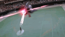 a person is standing in the middle of a stadium with a red light coming from the stands