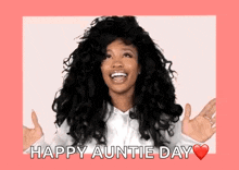 a woman with curly hair is smiling and holding her hands out in front of her face .
