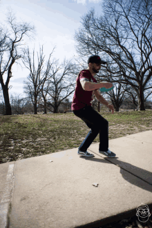 a man throwing a frisbee on a sidewalk wearing a t-shirt that says ' texas ' on it