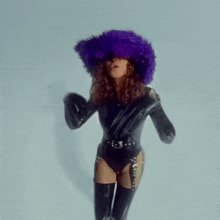a woman wearing a purple hat and gloves