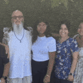 a man with a beard and glasses poses with his family