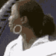 a woman wearing hoop earrings looks to the side