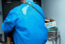 a man in a blue jacket is standing in front of a box that says ' ice ' on it