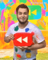 a man in a white shirt is holding a red youtube button