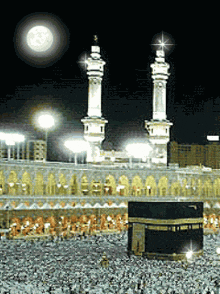 a full moon shines brightly over a mosque at night