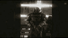 a group of soldiers are standing in a dark room with guns .