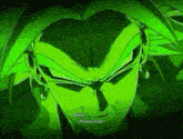 a close up of a green dragon ball z character 's face with a dark background .