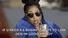 a woman wearing sunglasses and a blue jacket is holding a cup and talking on a cell phone .