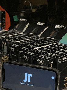 a display of xblack boxes next to a phone