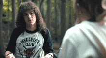 a man is wearing a shirt that says hellfire club on it
